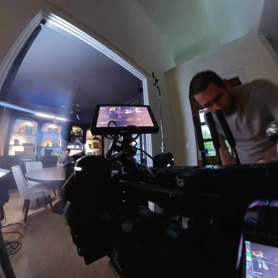 360-camera still of the camera monitor and a crew member on set