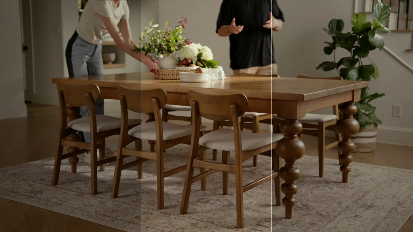 Camera monitor feed showing the crew dressing the Olivia dining table
