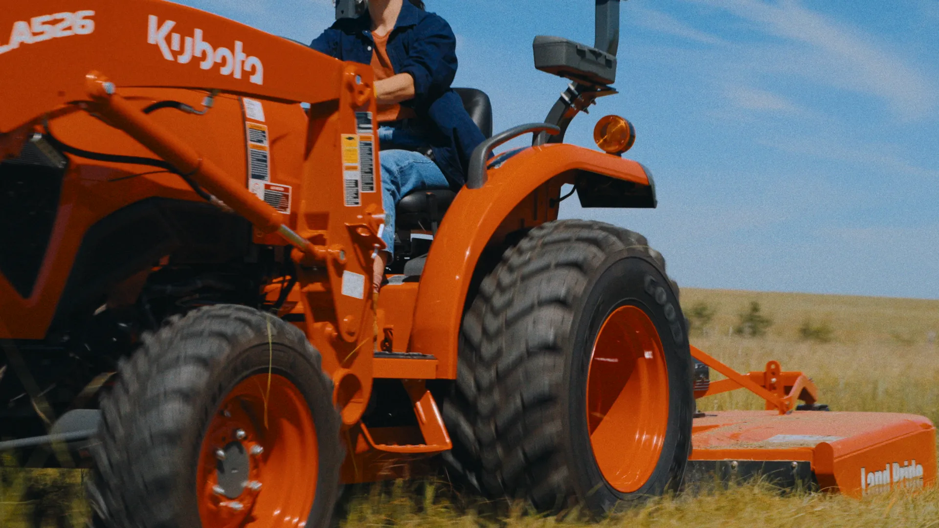 Kubota tractor with rotary mower from an ultra-low wide angle