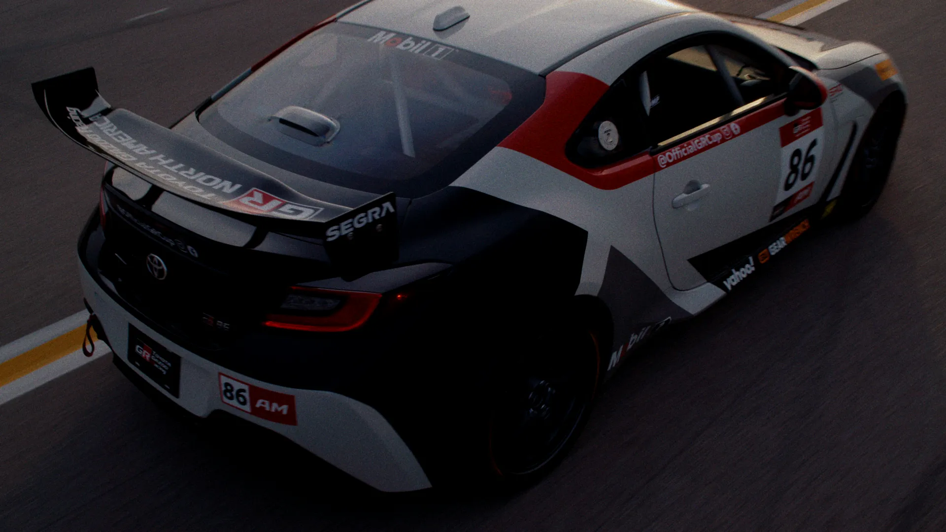 Toyota GR86 number 86 rear three-quarter tracking at speed