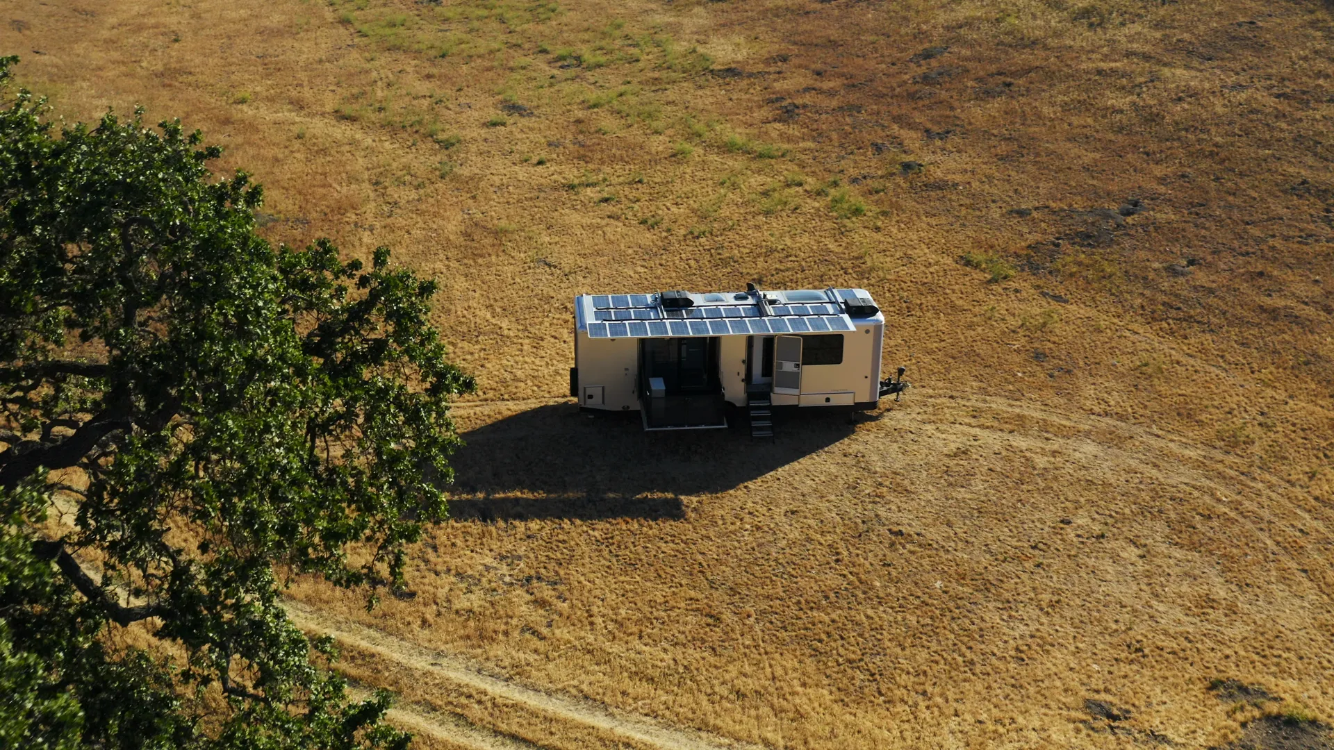 Living Vehicle trailer small in a golden hill bowl beside an oak