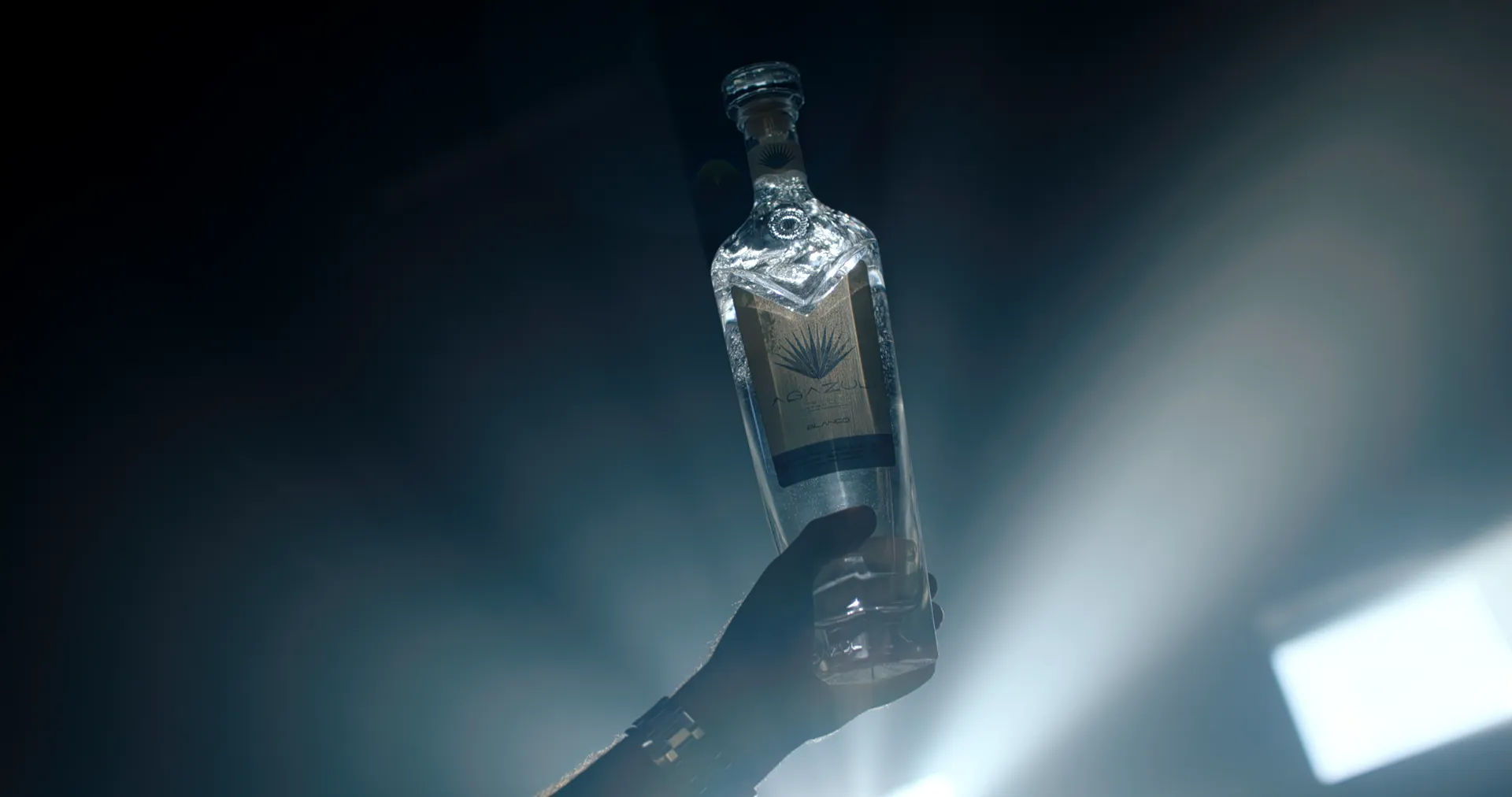 Agazul bottle raised into a hard rim light