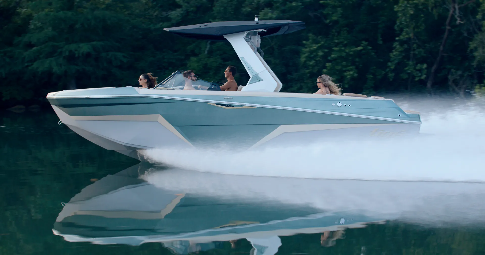Tige Z3 running at speed in full profile with its reflection on dark green water