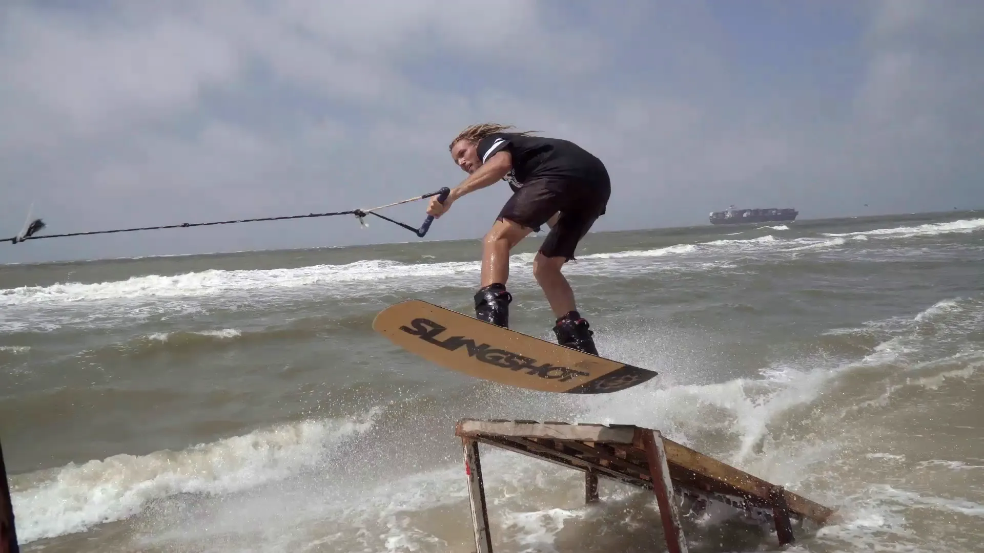 X Games Real Wake rider on a rusted ramp feature on open water