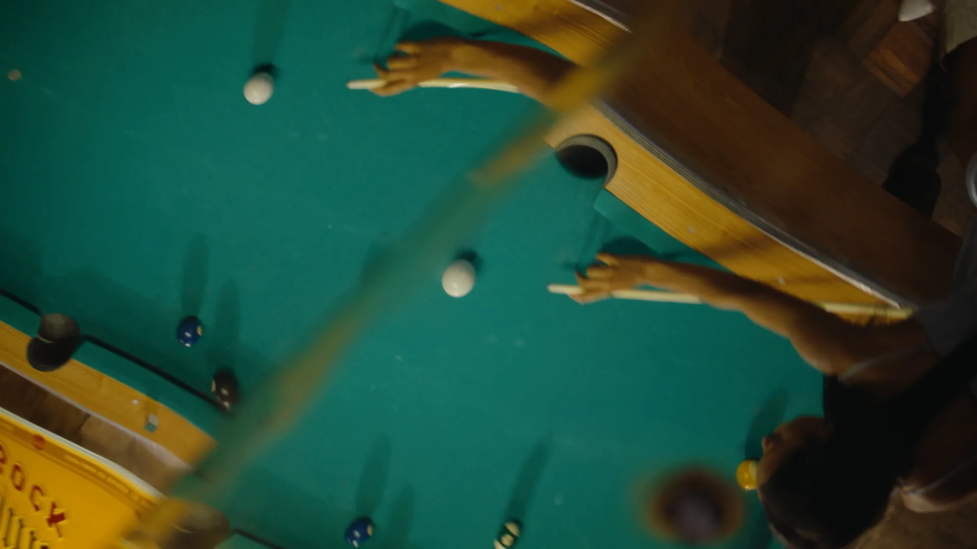 Overhead view of the break on a green pool table