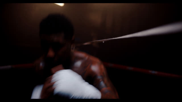A boxer in the ring, blurred by a slow shutter