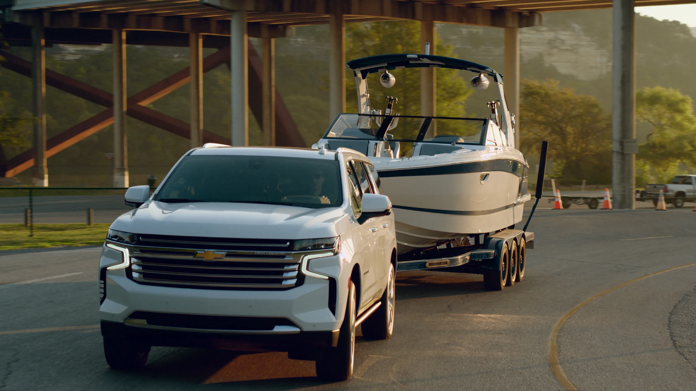 Low angle on the Suburban's grille at the lake, with the Cobalt on the water behind