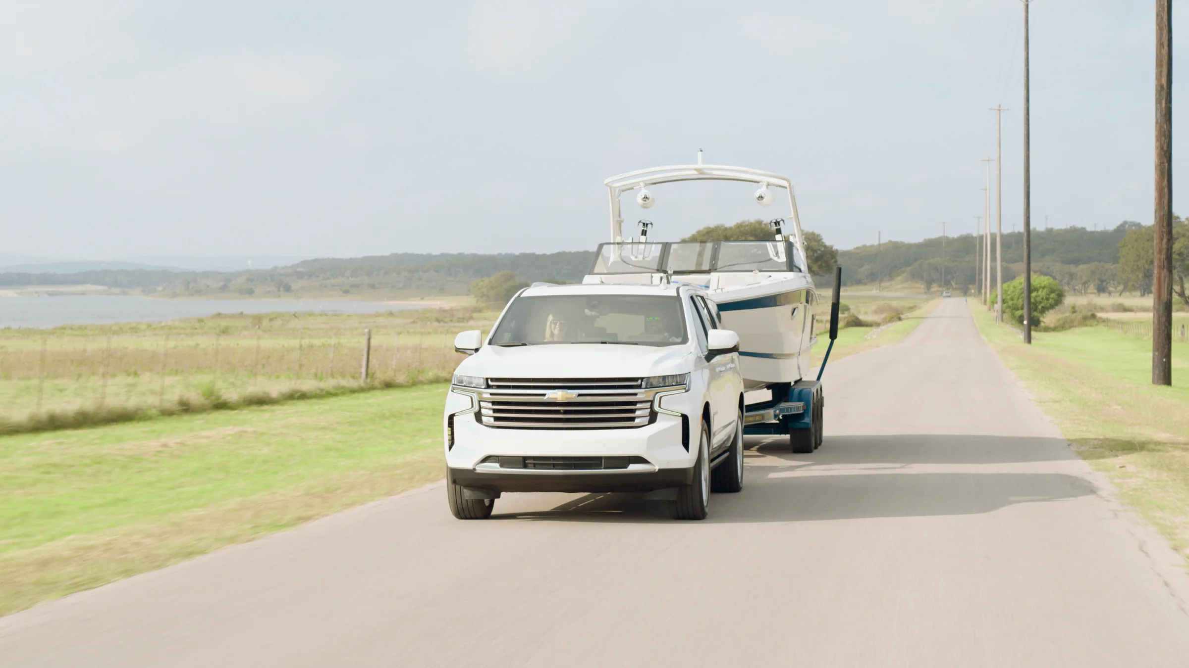 Head-on as the Suburban and Cobalt come down a lakeside country road