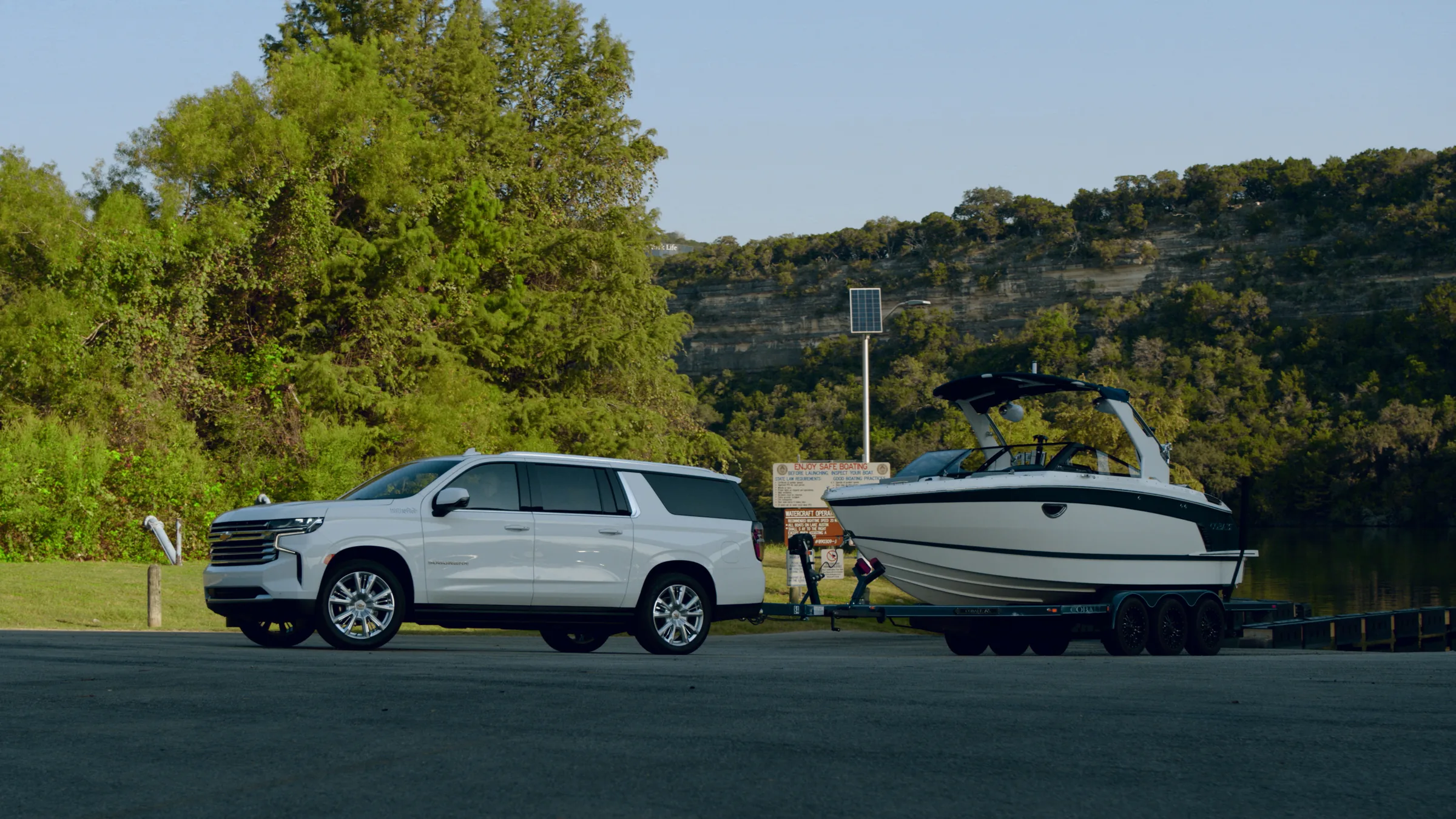 Wide profile of the Suburban and Cobalt at the ramp below the limestone bluff