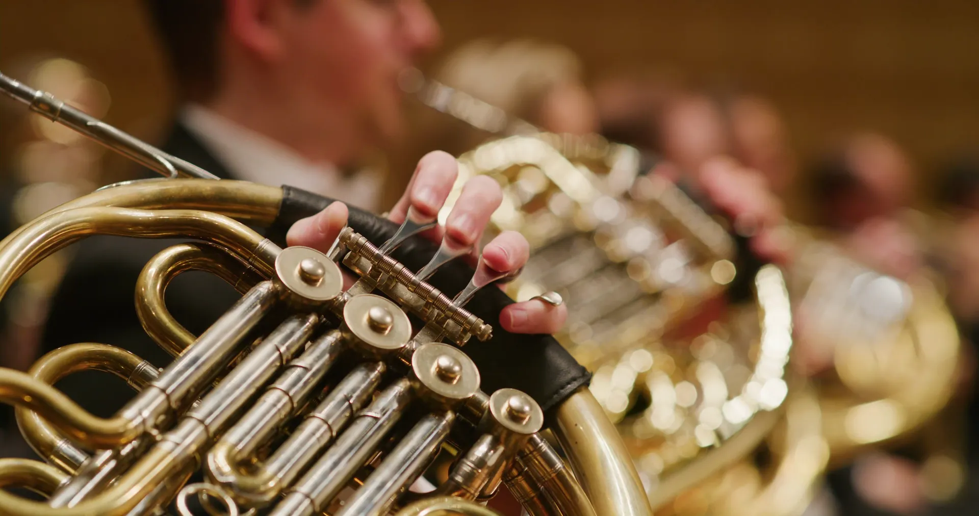 Close on the bells and valves of two French horns
