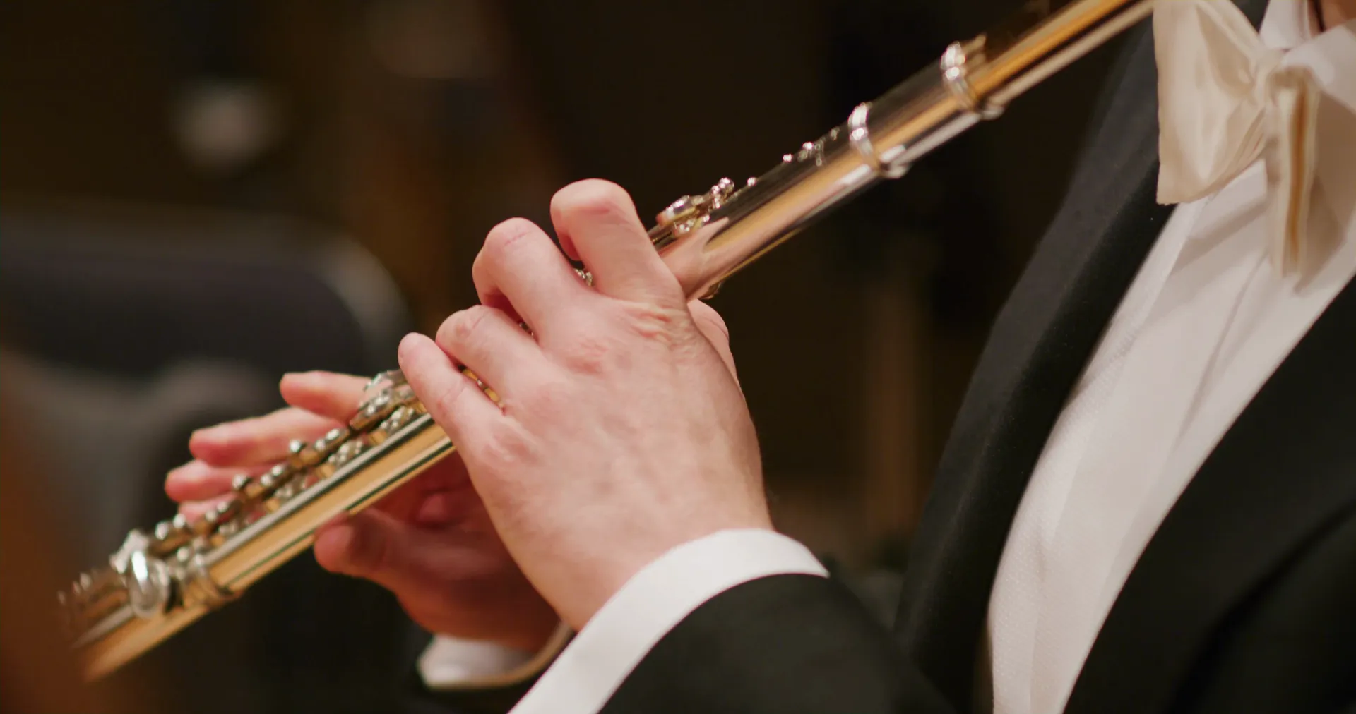 A flutist’s hands on the keys