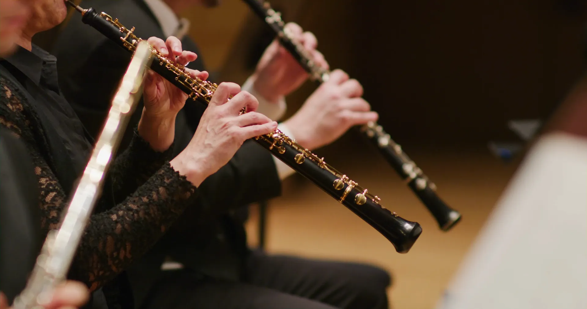 Two woodwind players side by side