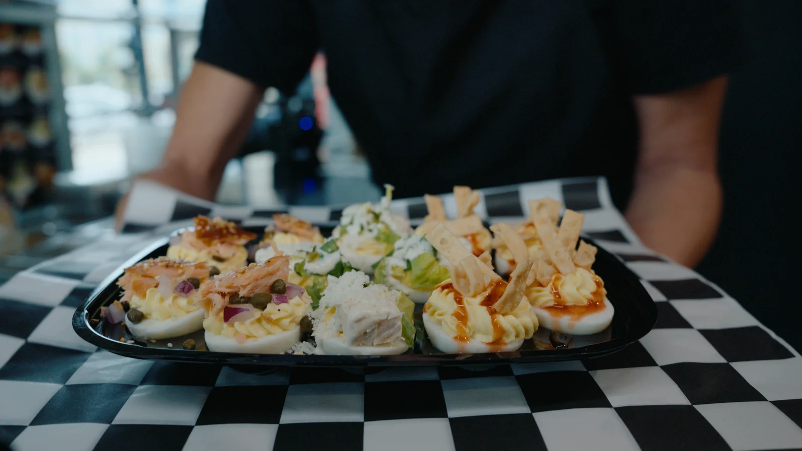 Platter of the full deviled egg menu set down on a checkerboard counter