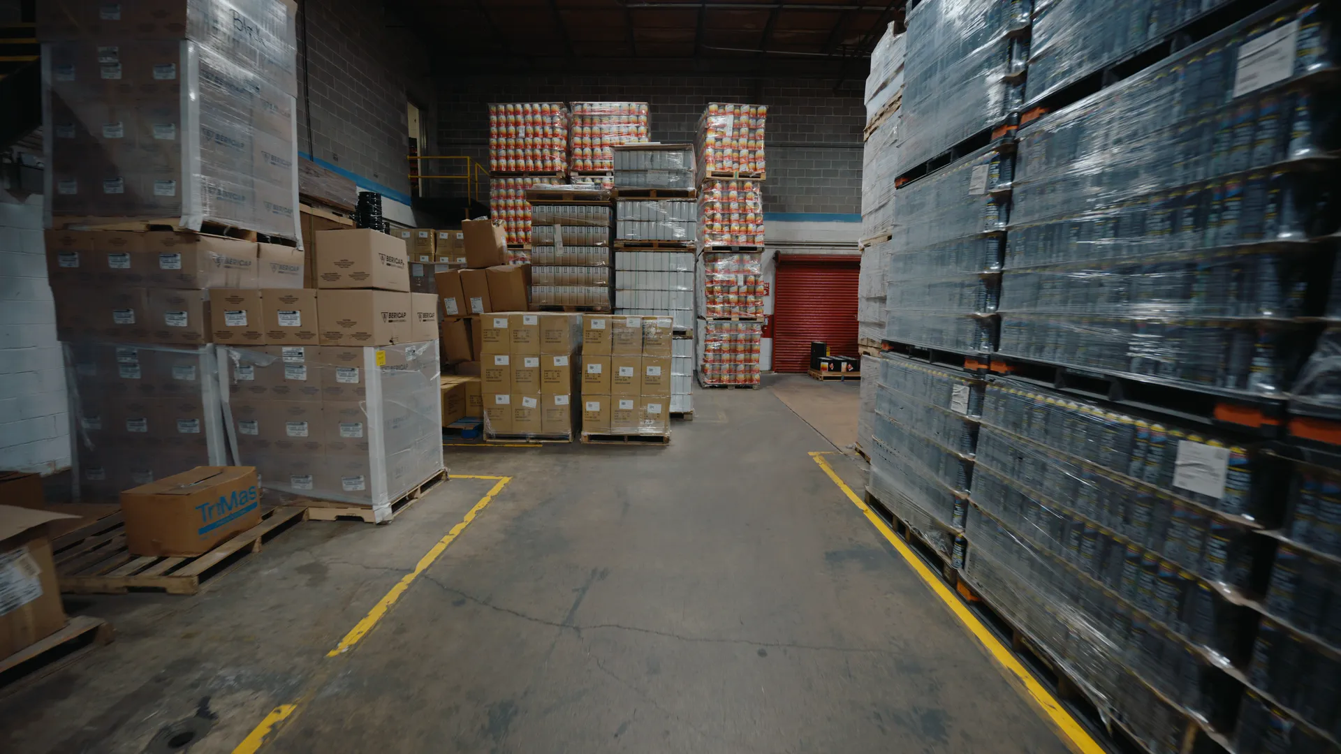A warehouse aisle lined with palletized finished goods