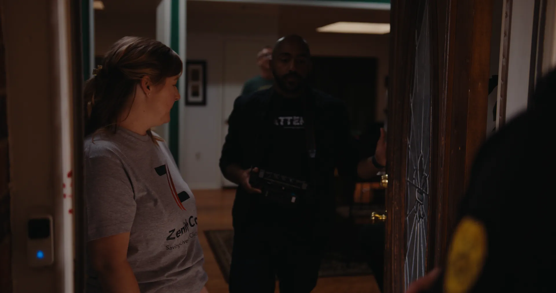 A woman at the front door with a police officer