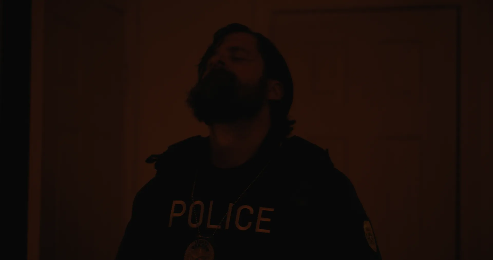 A police officer looking up in low light