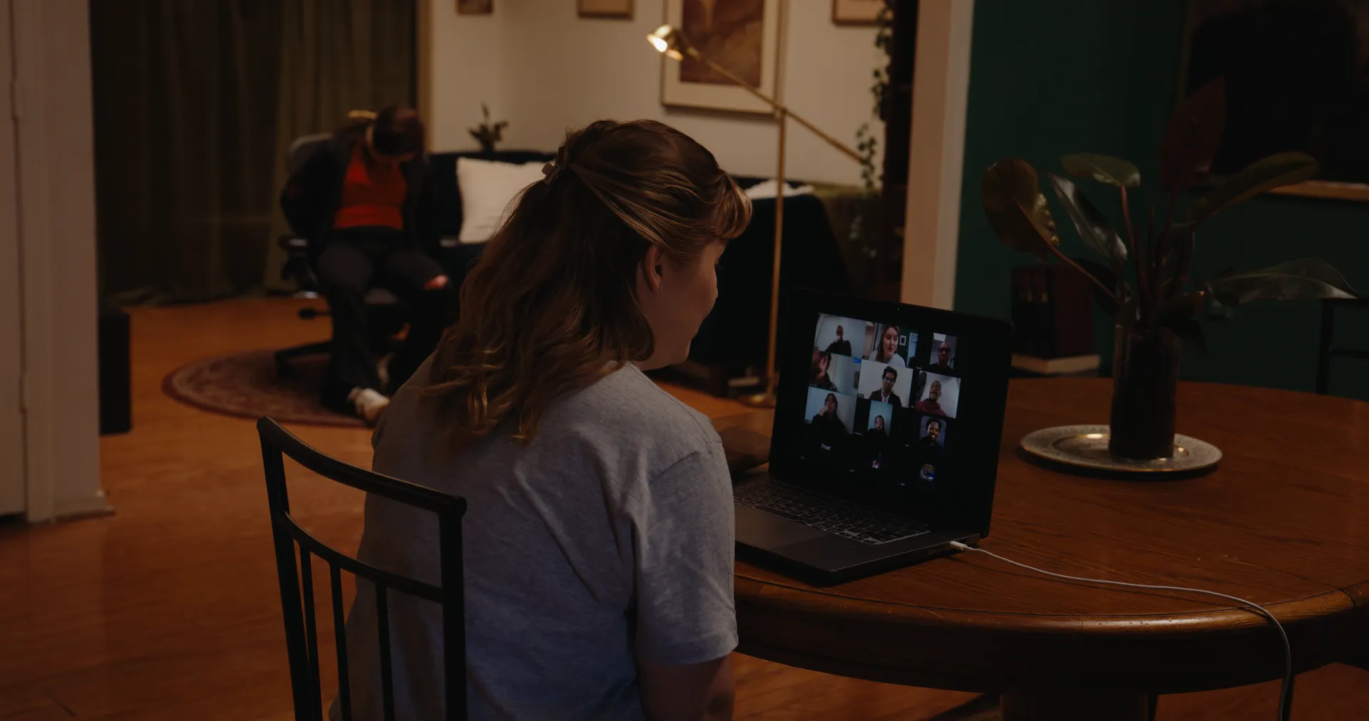 A woman at a dining table on a video call