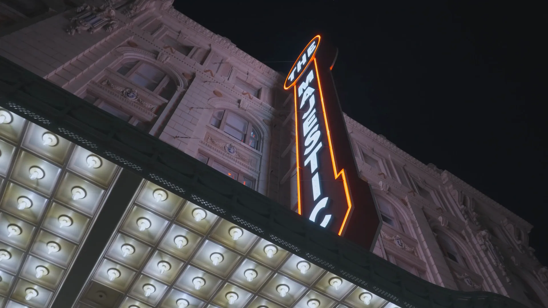 The Majestic Theatre neon sign and lit marquee in downtown Dallas at night