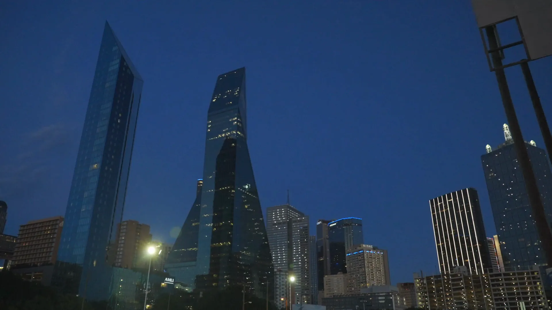 Downtown Dallas towers against a deep blue hour sky