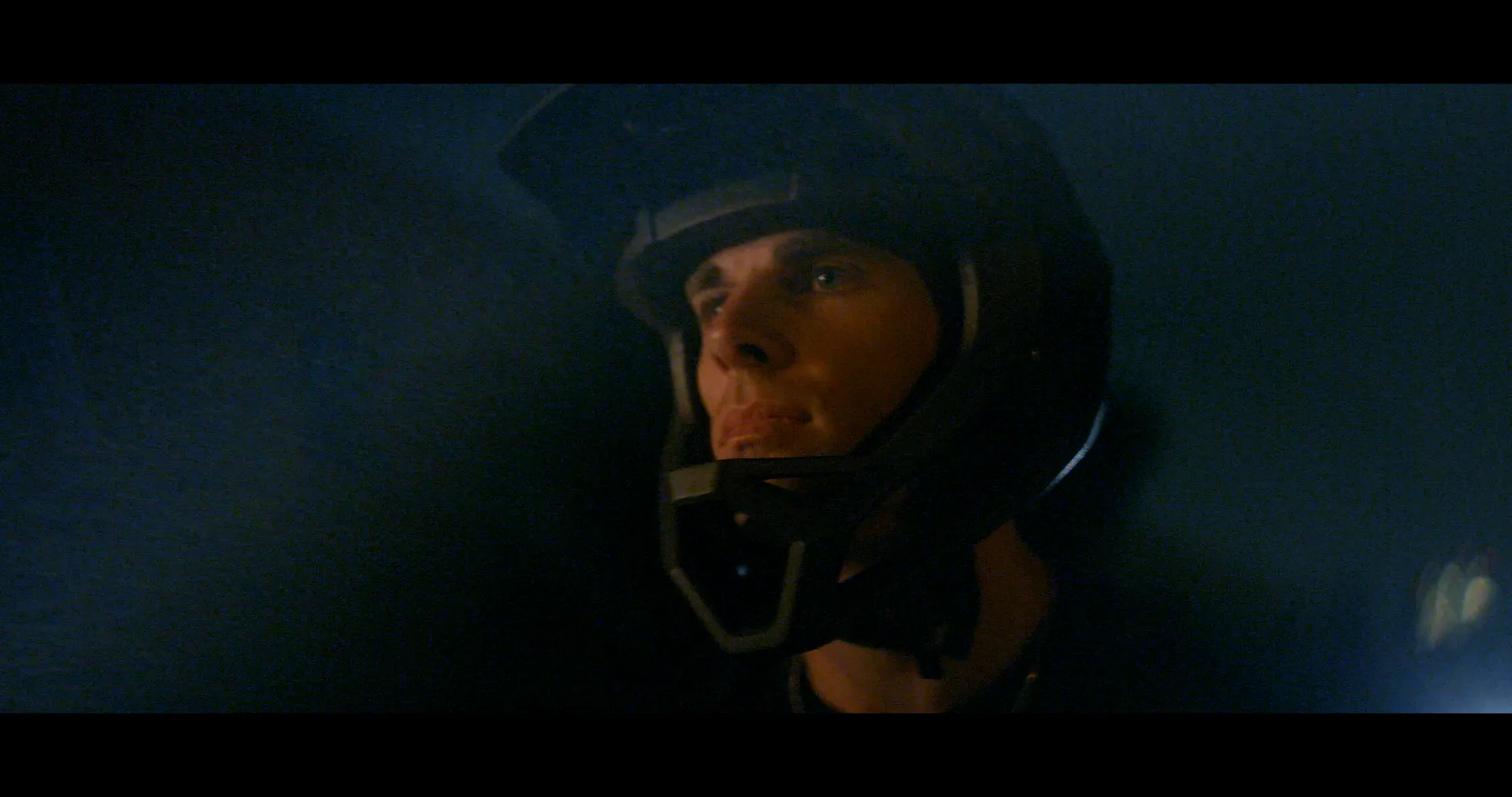 Close on a rider in a full-face helmet at night