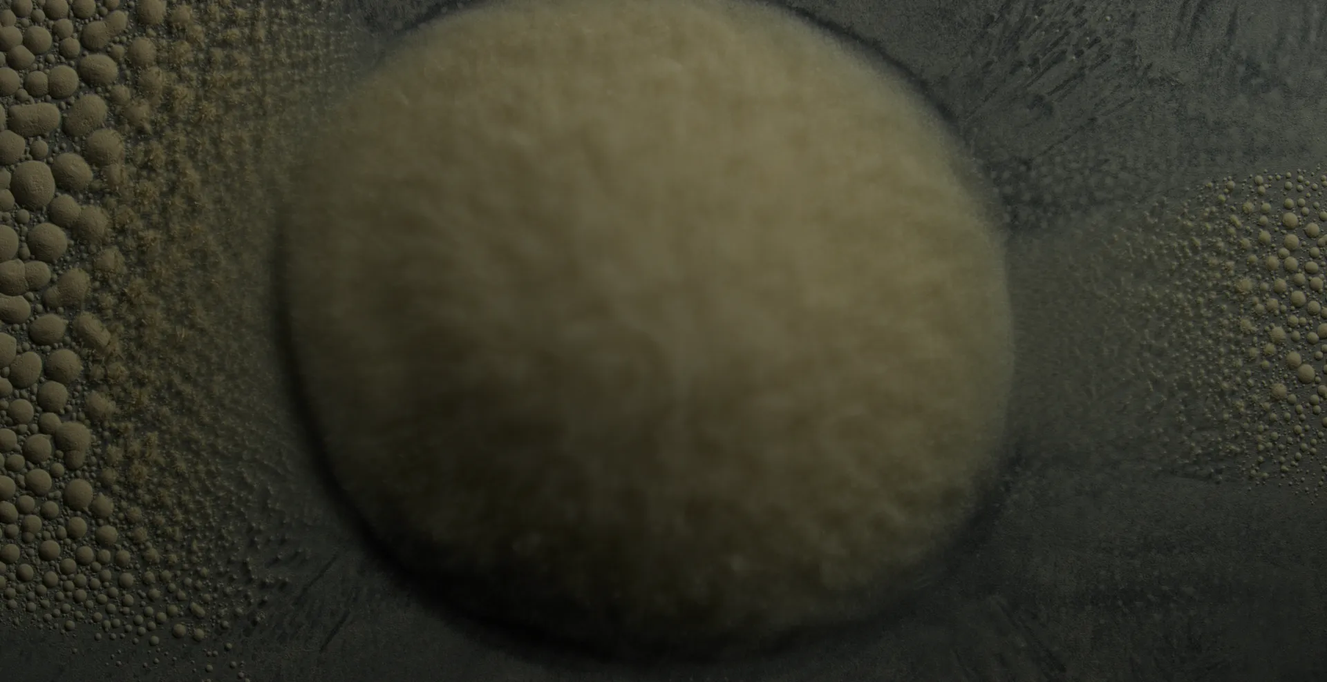 A single soft disc of powder resting on a field of tiny beads