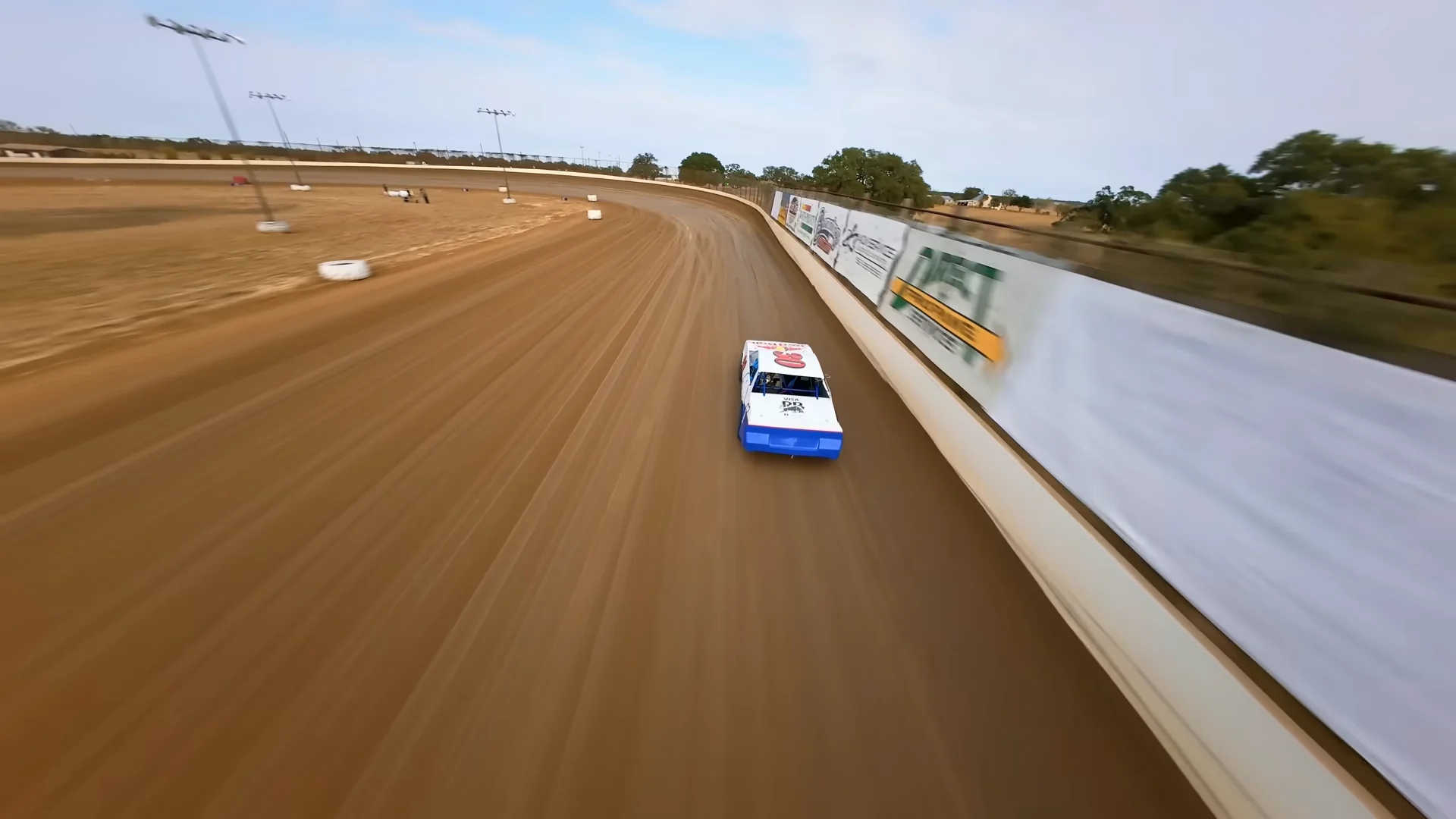 Yuki Tsunoda's number 22 Red Bull stock car sliding sideways across the dirt