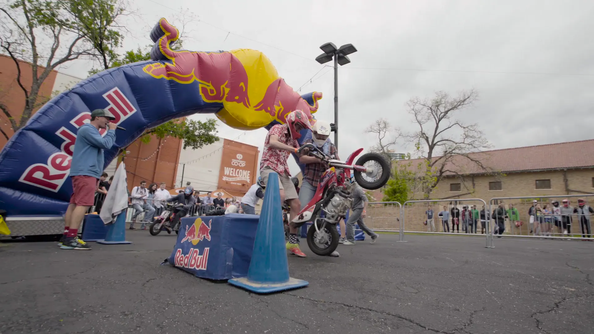 A rider lifting the front wheel under the Red Bull arch