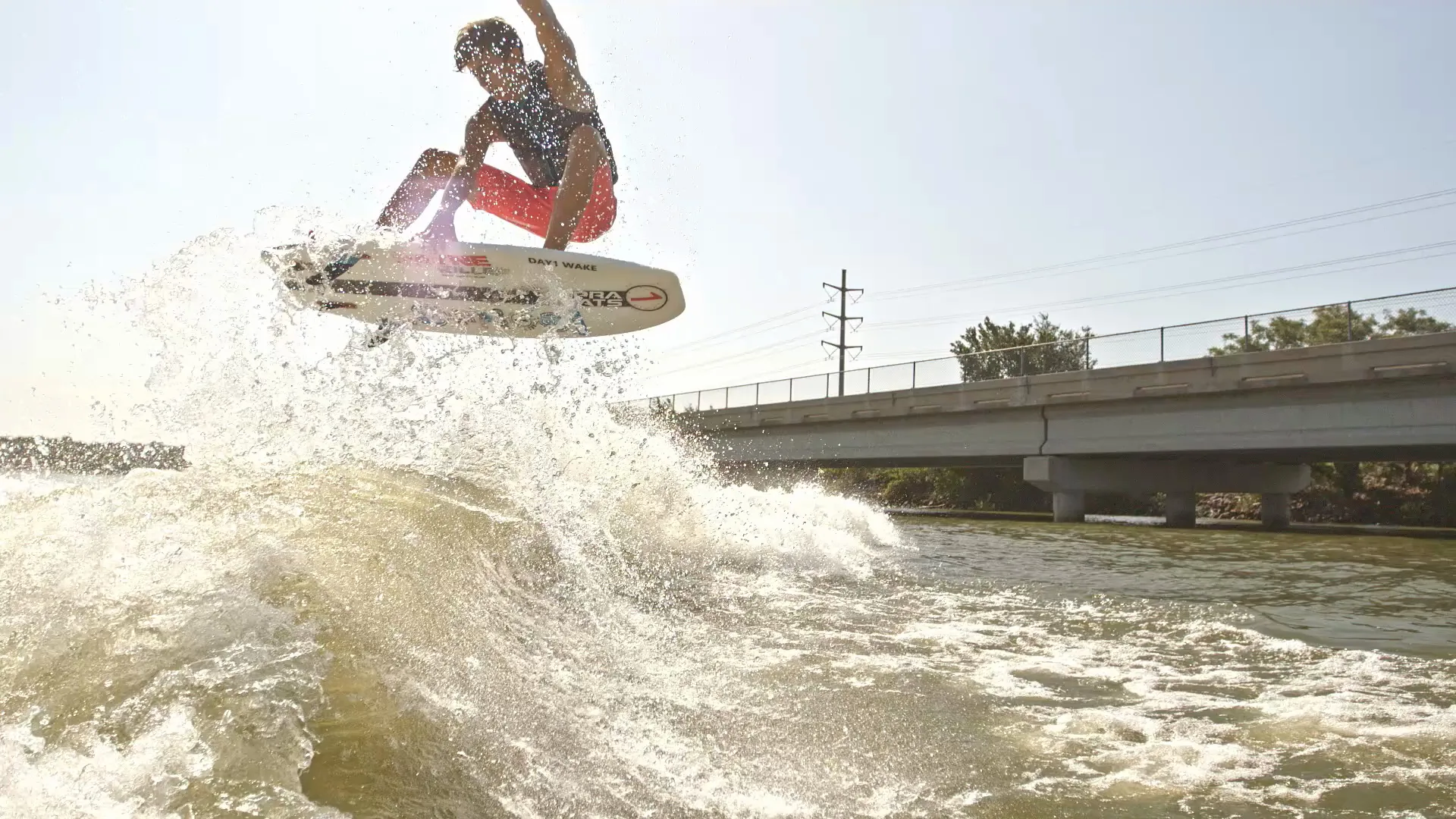 Parker Payne in the air off the wake, backlit spray flying