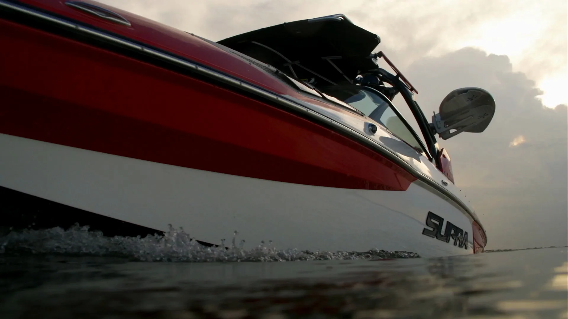 Low angle on the Supra's hull and tower against clouds