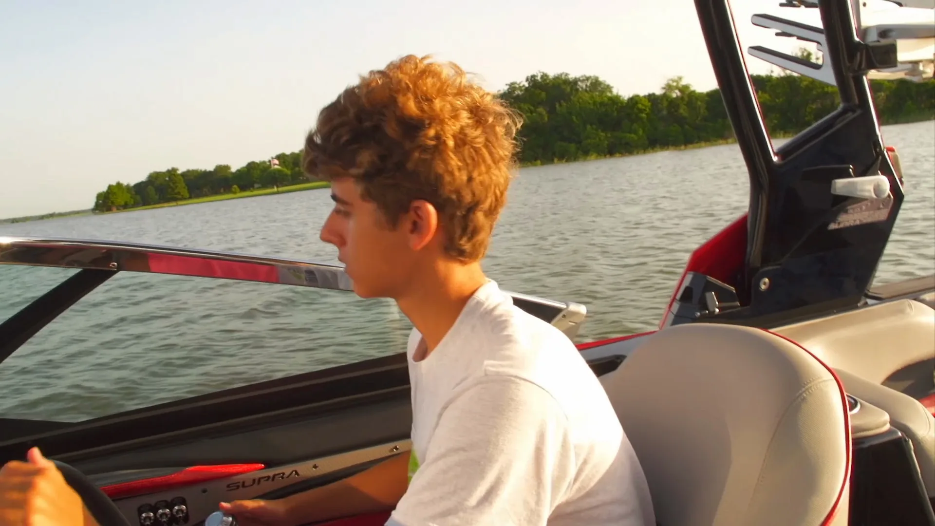 The driver at the helm of the Supra in golden-hour light