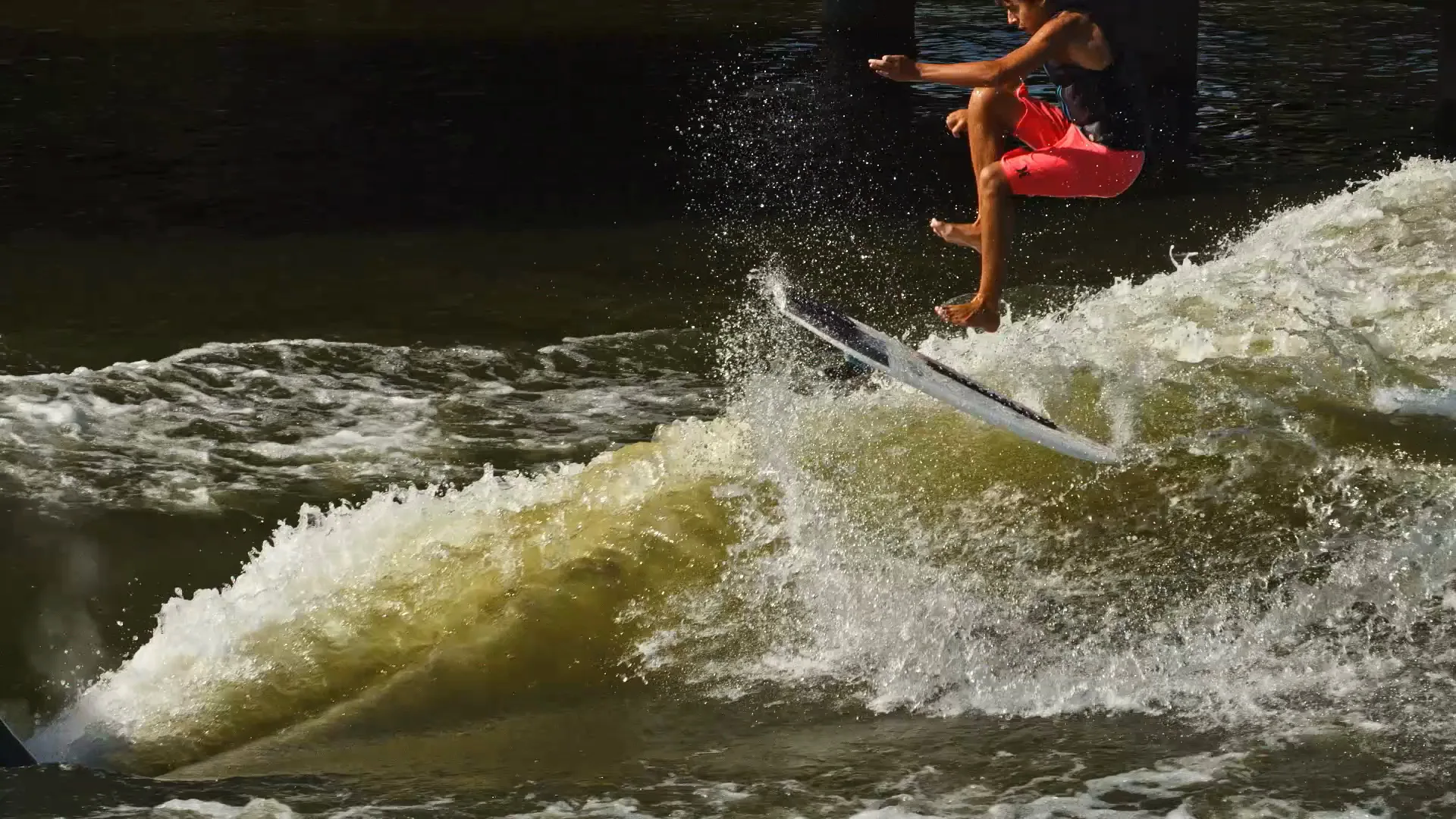 Parker Payne airborne above the wake as the board spins below him