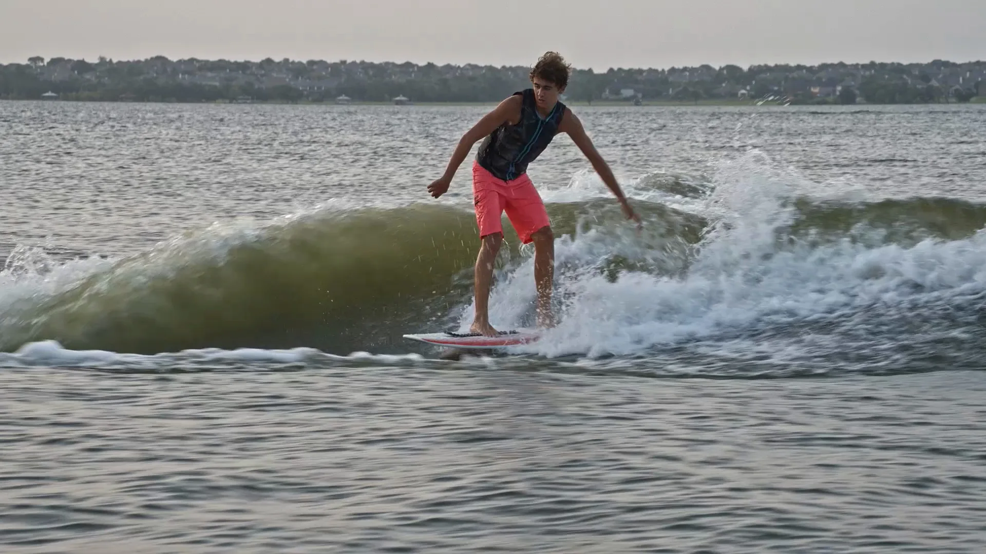 Parker Payne riding toward camera on the wake in hazy sunset light