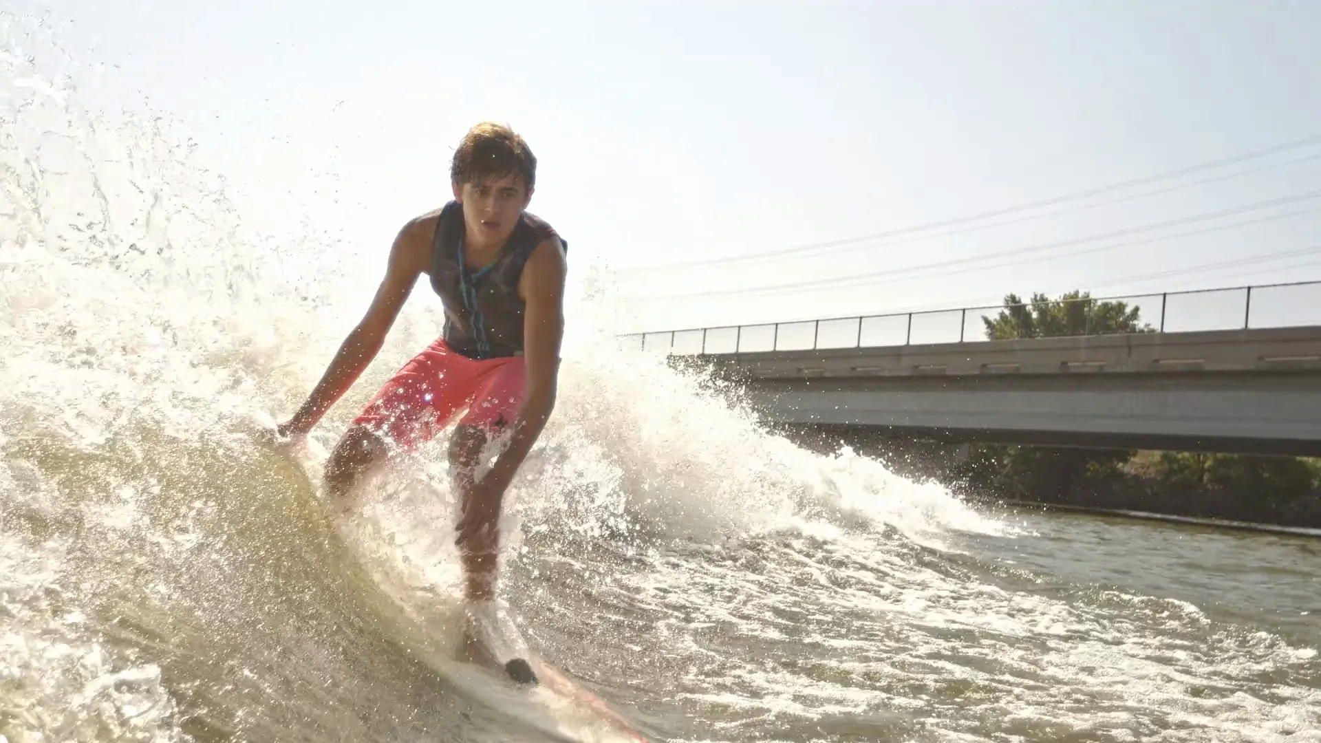 Low angle on Parker Payne facing the camera in a burst of spray