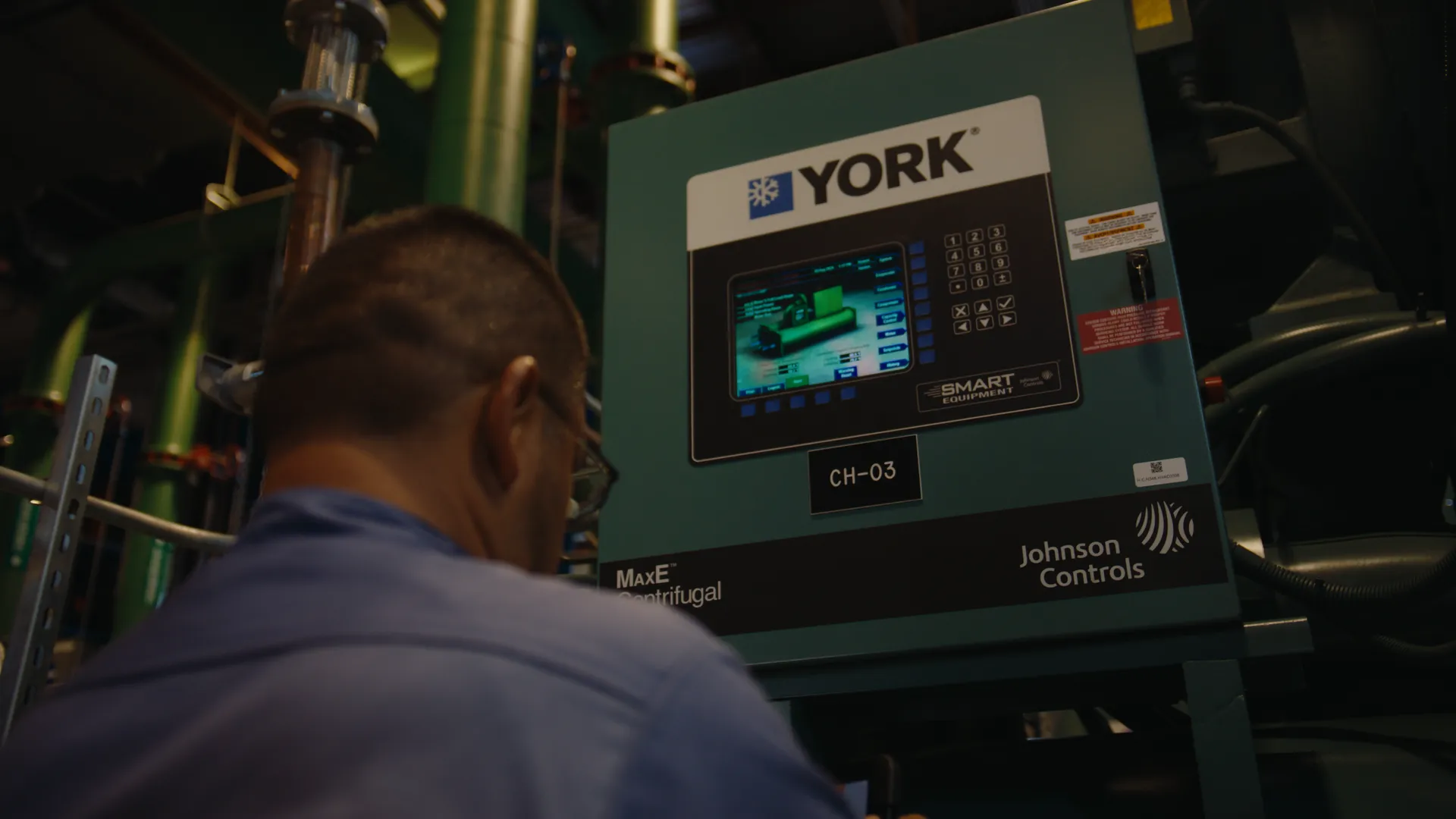 A technician at the control panel of a York chiller