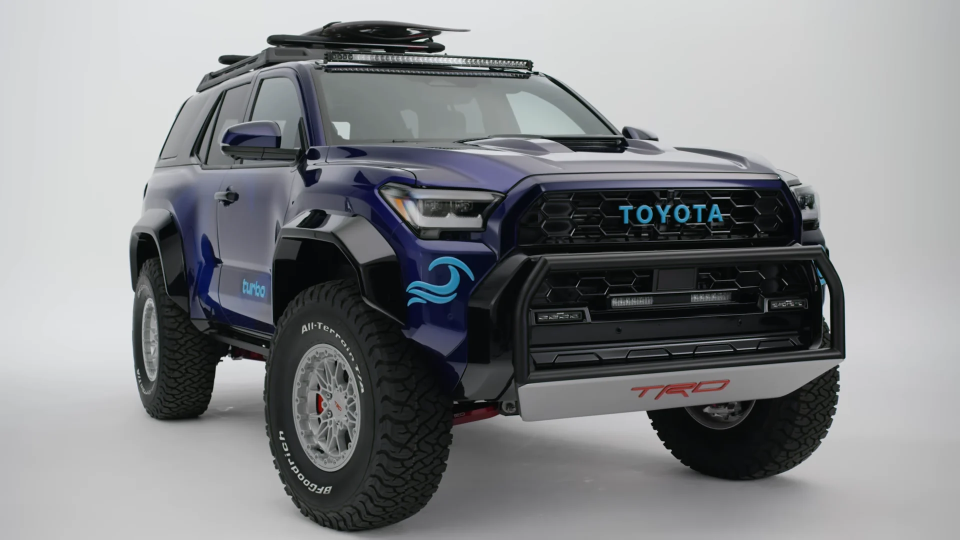 The finished 4Runner TRD Surf Concept in blue, front three-quarter on a white studio cyc