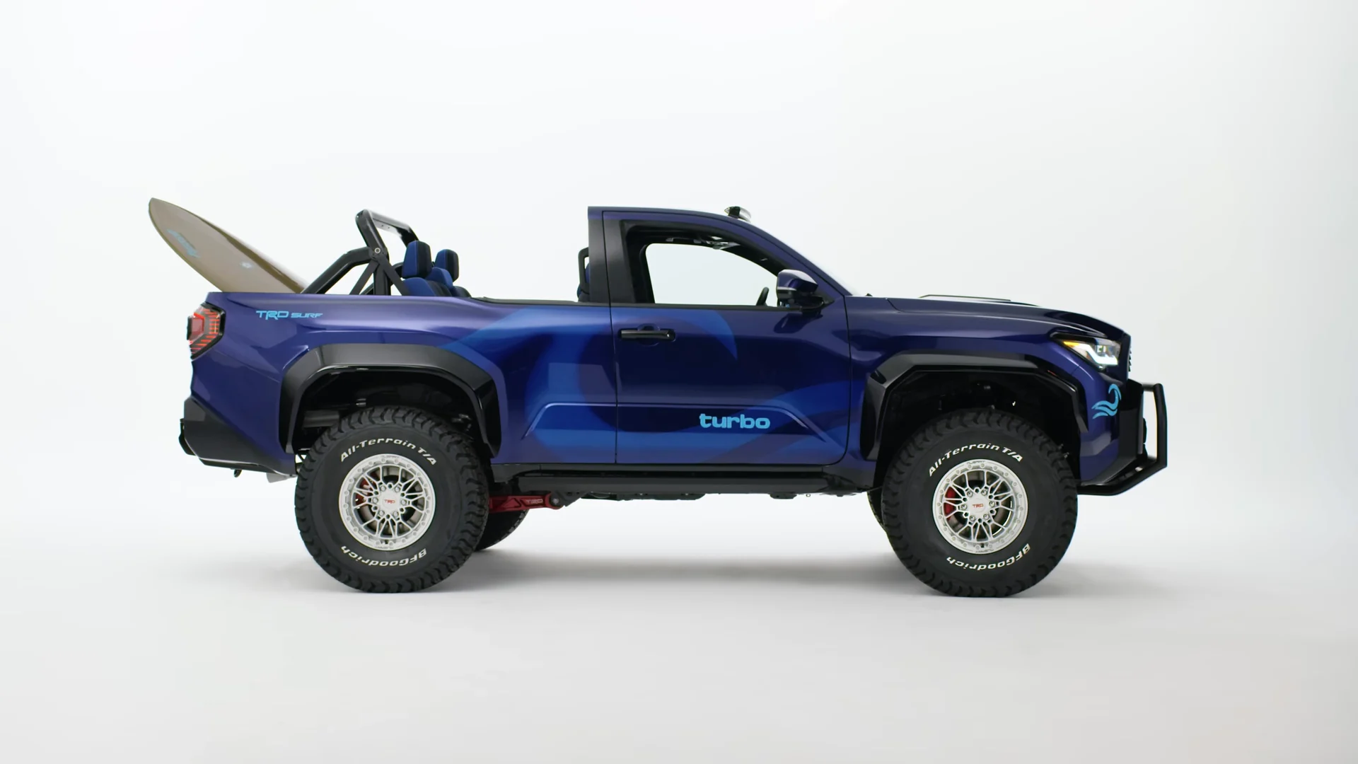 The open-top TRD Surf build in full side profile, two surfboards in the bed