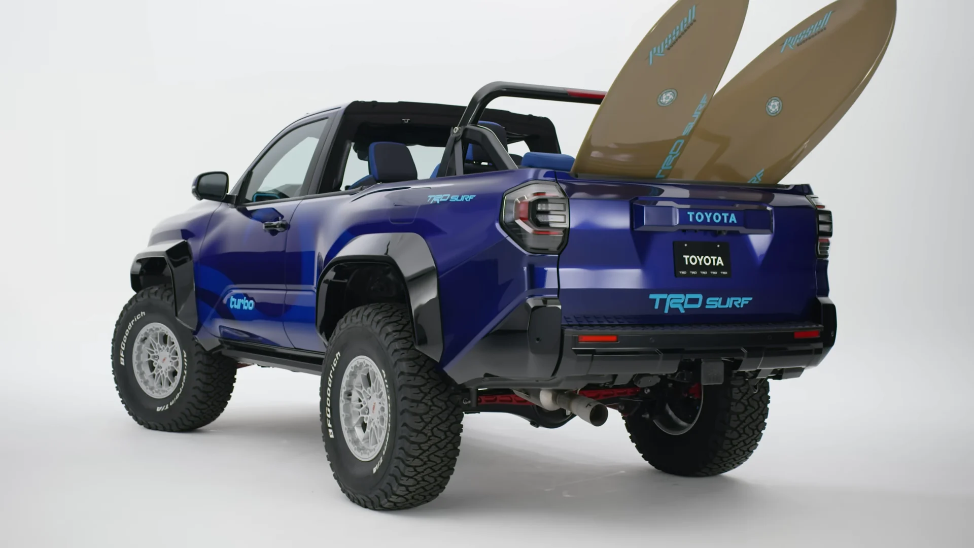 Rear three-quarter of the TRD Surf build, surfboards standing in the bed