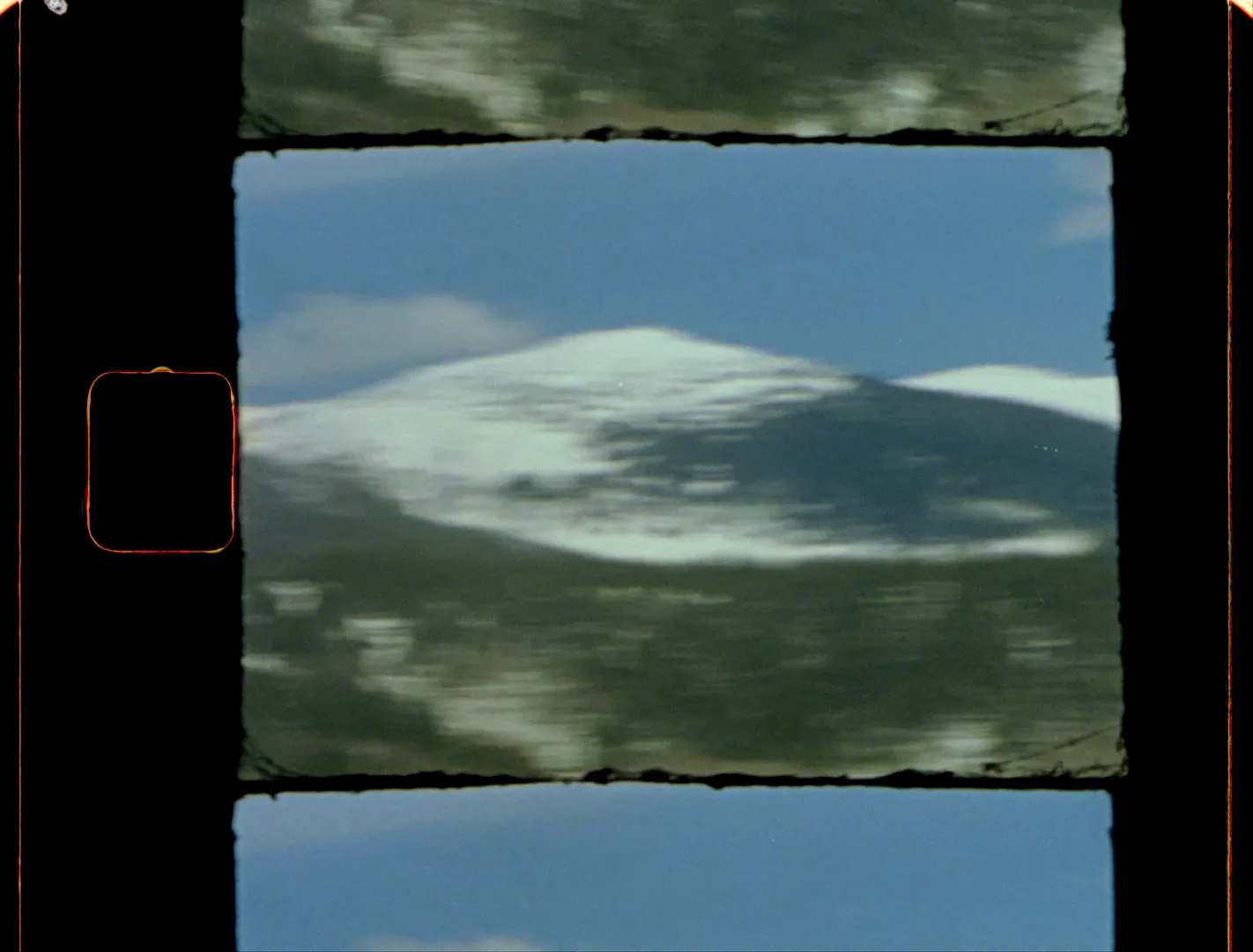 A snowy mountain ridge under a blue sky