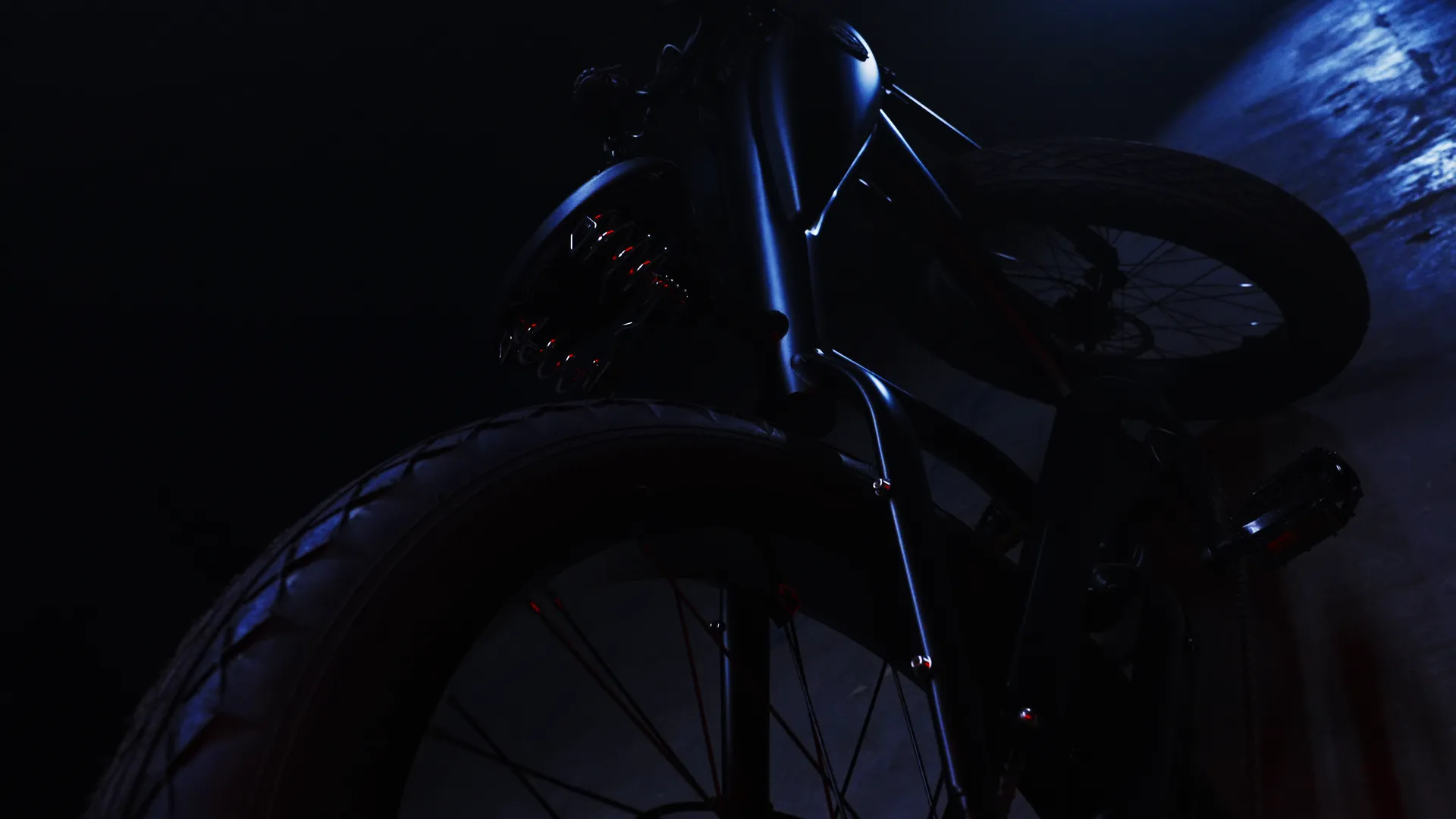 The fat tire and fender of the Destroyer in low blue light